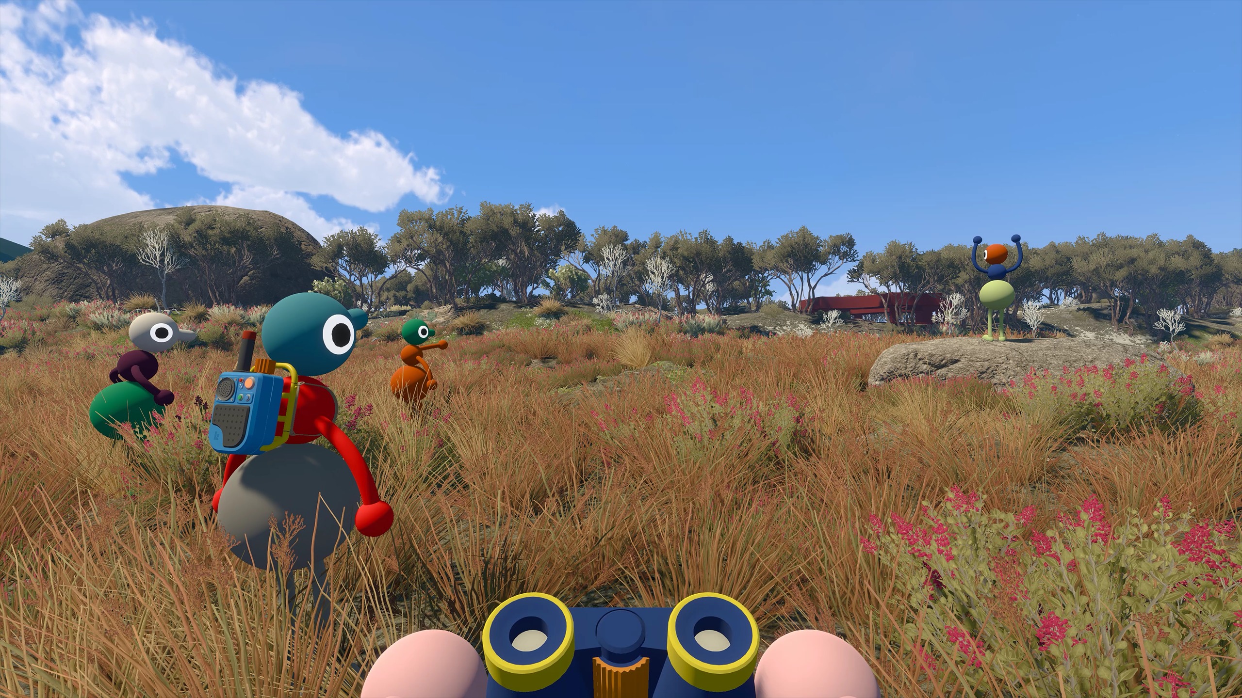Big Walk friends exploring a field with binoculars and a radio